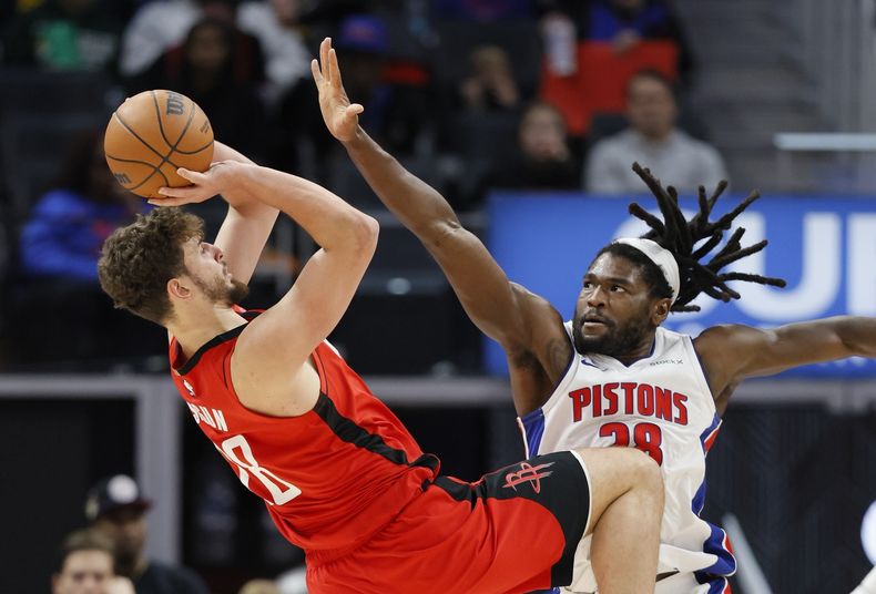 Alperen Sengun, izquierda, de los Rockets de Houston, intenta un disparo ante la presión defensiva de Isaiah Stewart, derecha, de los Pistons de Detroit, durante la primera mitad del juego de baloncesto de la NBA, el domingo 20 de noviembre de 2024, en Detroit. (AP Foto/Duane Burleson)