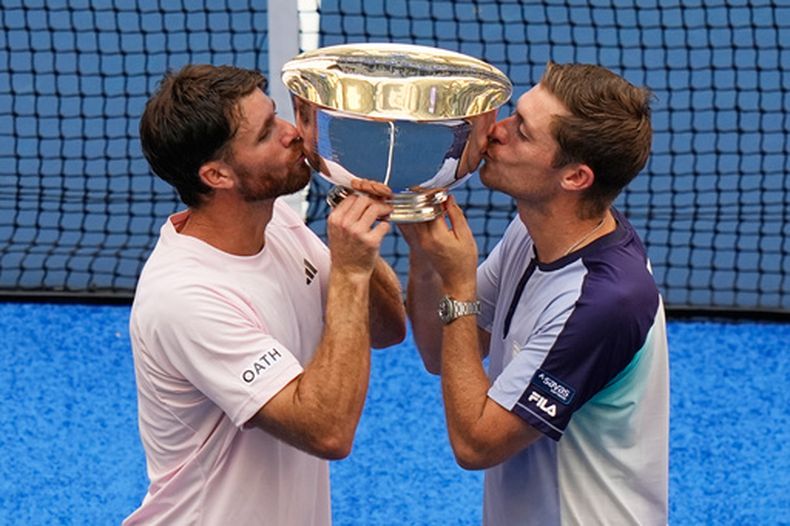 El estadounidense Christian Harrison y el británico Neal Skupski posan para una foto besando el trofeo tras ganar el torneo de dobles masculino del Abierto de Estados Unidos el sábado 12 de septiembre del 2026. (AP Foto/Frank Franklin II)