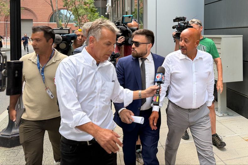 El alcalde de Lawrence, Massachusetts, Brian DePena, derecha, sale de un tribunal federal en Boston, el viernes 14 de agosto de 2026, tras una comparecencia inicial por cargos de haber obtenido fraudulentamente un préstamo por la pandemia de COVID-19 y usar el dinero para financiar su campaña de reelección, liquidar hipotecas de altos intereses y pagar impuestos. (AP Fotos/Michael Casey)