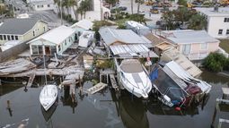 Esta imagen aérea tomada con dron muestra casas dañadas y un vehículo caído al agua tras la marejada ciclónica provocada por el huracán Helene, el sábado 28 de septiembre de 2024 en Madeira Beach, Florida. (Luis Santana/Tampa Bay Times via AP)