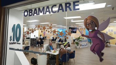 ARCHIVO - Un agente de seguros habla con clientes dentro de un local de Las Madrinas de los Seguros, en un centro comercial de Miami, el 5 de diciembre de 2023. (AP Foto/Rebecca Blackwell, Archivo)