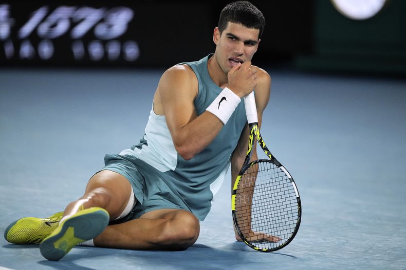 Carlos Alcaraz reacciona tras sufrir una caída en el partido contra Novak Djojovic en los cuartos de final del Abierto de Australia, el miércoles 22 de enero de 2025. (AP Foto/Vincent Thian)
