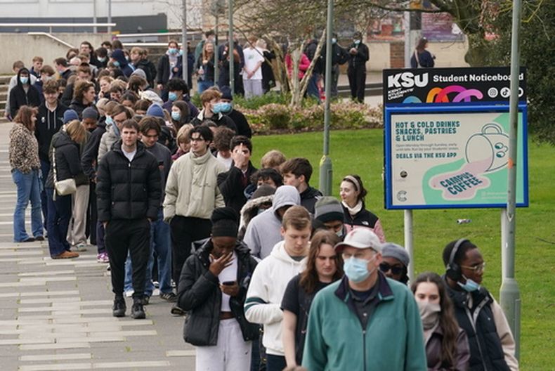 Un grupo de estudiantes forma una fila para recibir antibióticos fuera de un edificio en la Universidad de Kent tras un brote de meningitis, en Canterbury, Kent, Inglaterra, el lunes 16 de marzo de 2026. (Gareth Fuller/PA vía AP)