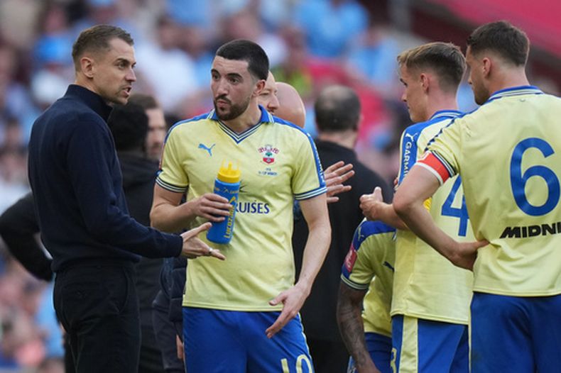 ARCHIVO - El técnico de Southampton Tonda Eckert (izquierda) conversa con sus jugadores durante la semifinal de la Copa FA contra Manchester City, el sábado 25 de abril de 2026, en Manchester. (AP Foto/Kin Cheung)