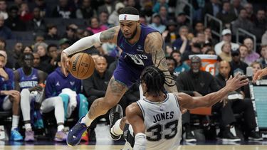 Miles Bridges, alero de los Hornets de Charlotte, comete una falta sobre Tre Jones, de los Spurs de San Antonio, en el partido del viernes 19 de enero de 2024 (AP Foto/Chris Carlson)
