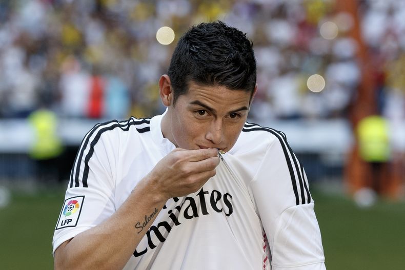 El jugador de Real Madrid, James Rodr&iacute;guez, besa la camiseta del club durante su presentaci&oacute;n oficial el martes, 22 de julio de 2014, en Madrid. (AP Photo/Daniel Ochoa de Olza)