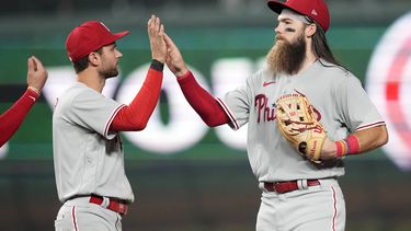 El campocorto Trea Turner y el jardinero Brandon Marsh de los Filis de Filadelfia celebran el triunfo de su equipo ante los Cachorros de Chicago el martes 27 de junio del 2023. (AP Foto/Charles Rex Arbogast)