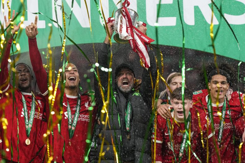 El técnico de Liverpool Jurgen Klopp alza el trofeo tras la victoria de su equipo 1-0 ante Chelsea en la final de la Copa de la Liga inglesa, el domingo 25 de febrero de 2024. (AP Foto/Alastair Grant)