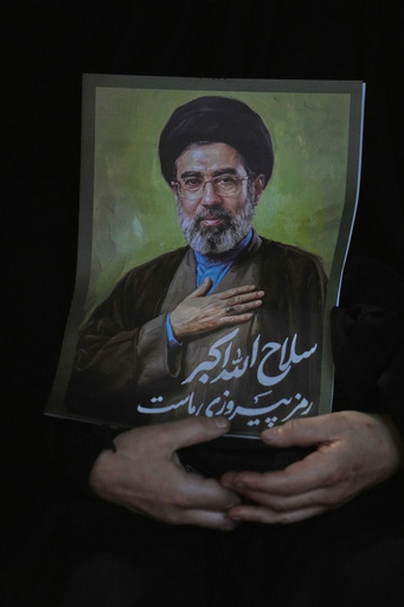 Una mujer sostiene un cartel con la imagen del líder supremo de Irán, Moytaba Jamenei, durante una reunión progobierno en la plaza de la Revolución Islámica en Teherán, Irán, el sábado 30 de mayo de 2026. (AP Foto/Vahid Salemi)
