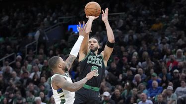 El alero de los Celtics de Boston Jayson Tatum lanza el balón sobre el base de los Bucks de Milwaukee Damian Lillard en el encuentro de la NBA del miércoles 20 de marzo del 2024. (AP Foto/Steven Senne)