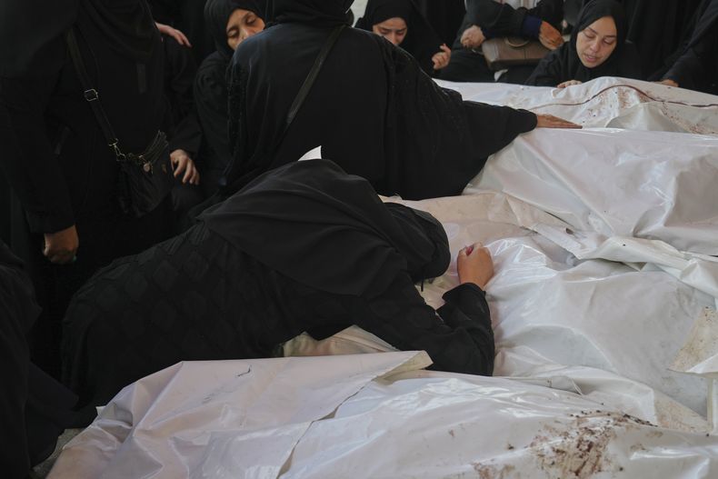 Dolientes asisten a un funeral para sus familiares que murieron en un bombardeo israelí, el sábado 12 de julio de 2025, en Deir al Balah, Franja de Gaza. (AP Foto/Abdel Kareem Hana)