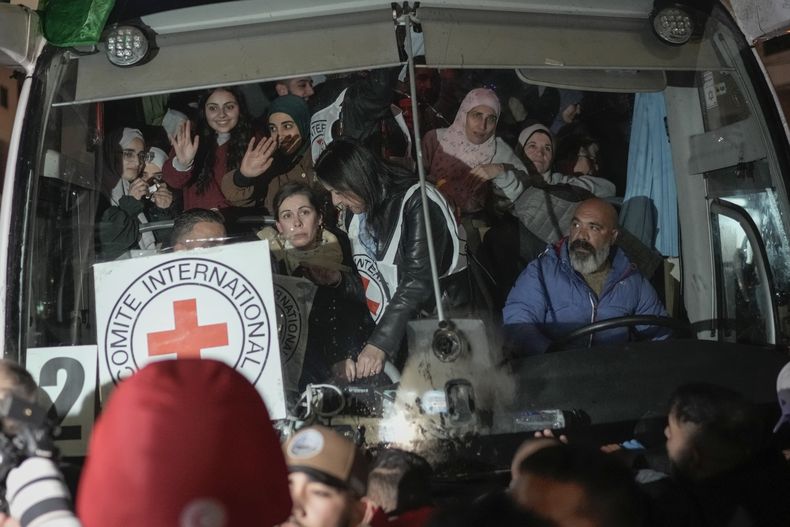 ARCHIVO - Mujeres palestinas que fueron liberadas de una prisión israelí como parte de un acuerdo de cese al fuego entre Israel y Hamás saludan desde un autobús a su llegada a la ciudad de Beitunia, en Cisjordania, el lunes 20 de enero de 2025. (AP Foto/Leo Correa, Archivo)
