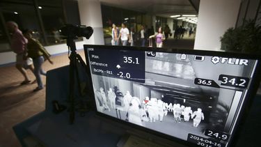 americateve | En esta foto del 16 de abril del 2014 los pasajeros pasan por un detector en el &aacute;rea de cuarentena m&eacute;dica en el aeropuerto internacional de Panaque al sur de Manila, Filipinas. Un experto dijo que el reciente brote de un virus relacionado co