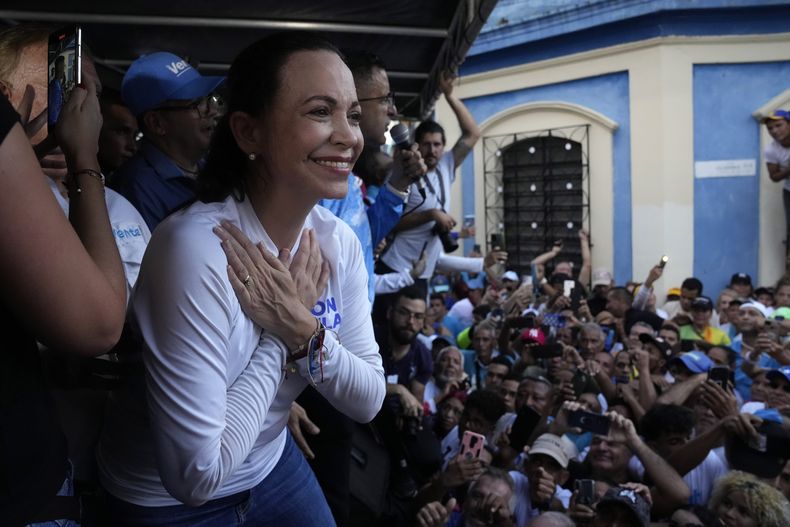ARCHIVO - La candidata presidencial de la oposición María Corina Machado reconoce a sus partidarios con un abrazo simbólico durante un mitin de campaña en Valencia, estado de Carabobo, Venezuela, el 5 de octubre de 2023. (AP Foto/Ariana Cubillos, Archivo)
