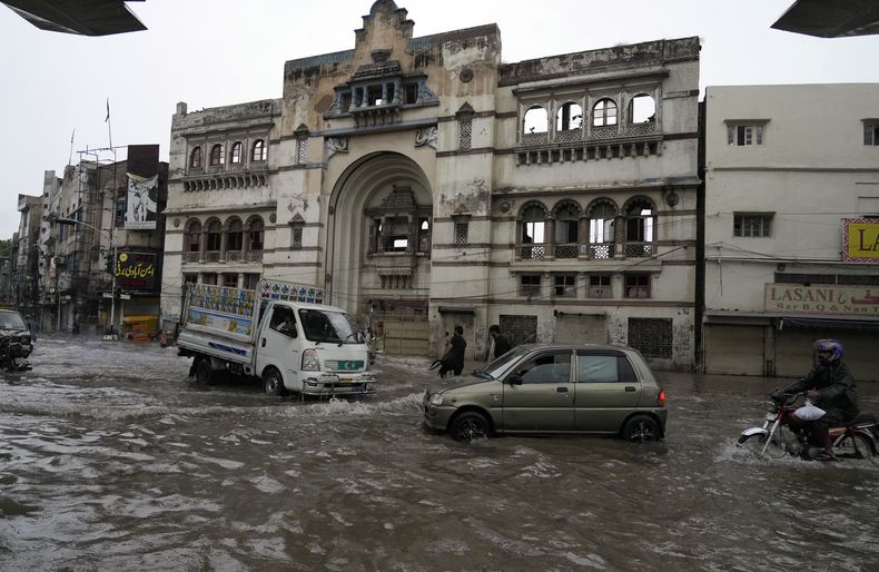 Motociclistas y autos pasan por una calle inundada por las lluvias del monzón en Lahore, Pakistán, el jueves 1 de agosto de 2024. (AP Foto/K.M. Chaudary)