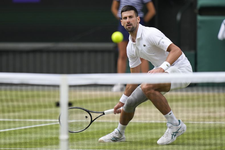 Novak Djokovic, de Serbia, regresa con un golpe de derecha a Carlos Alcaraz, de España, durante la final individual masculina del campeonato de tenis de Wimbledon en Londres, el domingo 14 de julio de 2024. (Foto AP/Alberto Pezzali)