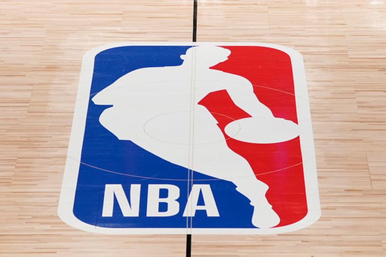 ARCHIVO - El logotipo de la NBA en el centro de una duela de baloncesto en Lake Buena Vista, Florida, el 28 de agosto de 2020. (AP Foto/Ashley Landis, Archivo)