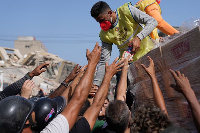 Miembros de una organización religiosa distribuyen alimentos a las personas afectadas dos días después del terremoto que azotó La Guaira, Venezuela, el viernes 26 de junio de 2026. (AP Foto/Ariana Cubillos)