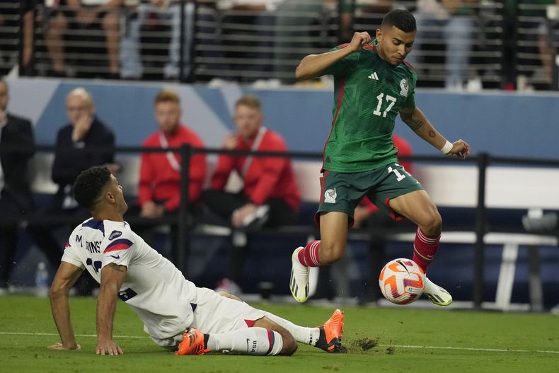 El estadounidense Miles Robinson se barre ante el mexicano Oberlín Pineda en las semifinales de la Liga de Naciones de la CONCACAF, el jueves 15 de junio en Las Vegas. (AP Foto/John Locher)