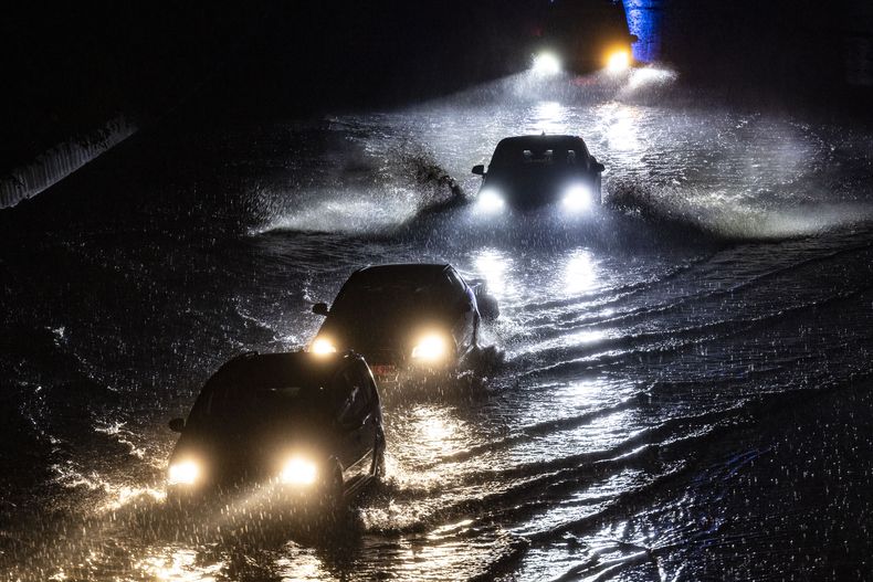 Vehículos circulan por una zona anegada en la autovía A59 durante un aguacero, el 22 de junio de 2023, en Duisburg, Alemania. (Christoph Reichwein/dpa vía AP)