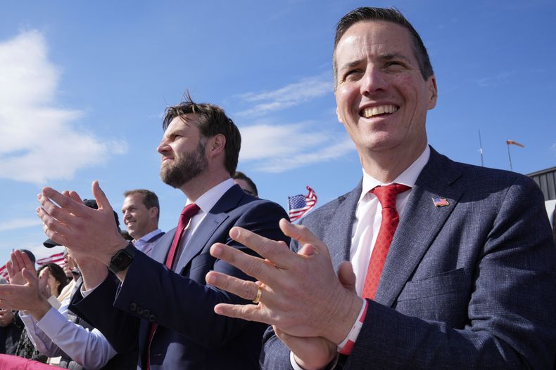 ARCHIVO - El senador J.D. Vance, al centro, y el candidato al Senado estadounidense Bernie Moreno, derecha, aplauden mientras el candidato presidencial republicano y expresidente Donald Trump habla en un mitin de campaña, el 16 de marzo de 2024, en Vandalia, Ohio. (AP Foto/Jeff Dean, archivo)