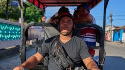 Liexer De La Cruz conduce su triciclo con clientes en Minas, en la provincia cubana de La Habana, el viernes 4 de septiembre de 2026. (AP Foto/Ramon Espinosa)