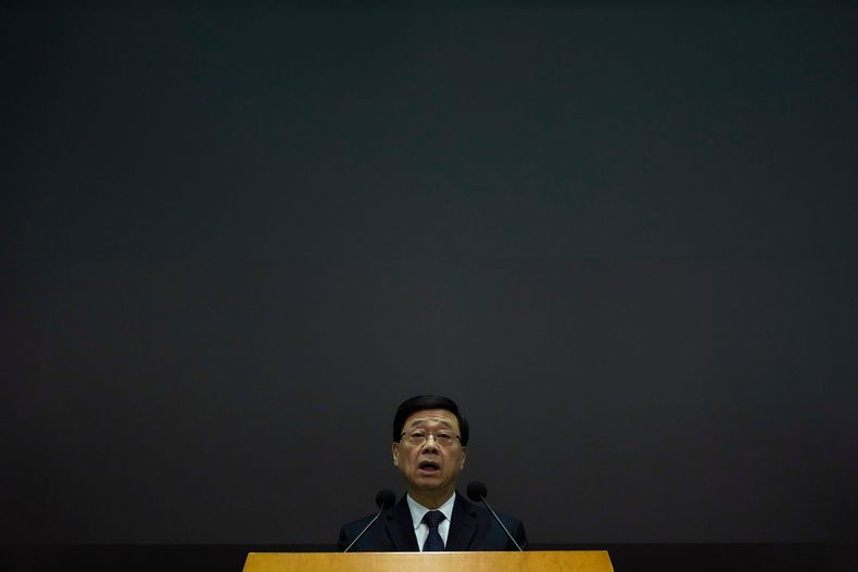 El jefe de gobierno de Hong Kong, John Lee habla durante una conferencia de prensa con una pantalla oscurecida tras un letal incendio en Hong Kong el martes 2 de diciembre de 2025. (AP Foto/Ng Han Guan)