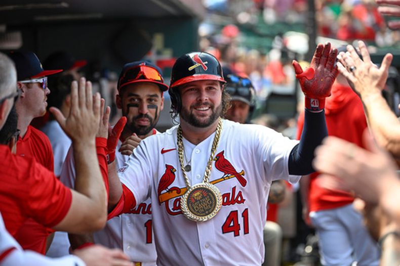 Alec Burleson (41), de los Cardenales de San Luis, es felicitado en el dugout después de batear un cuadrangular solitario en la quinta entrada del juego de béisbol de Grandes Ligas contra los Rockies de Colorado el domingo 9 de agosto de 2026, en San Luis. (AP Foto/Joe Puetz)