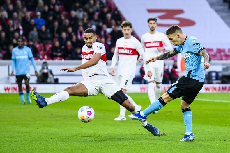 El español Alex Grimaldo del Bayer Leverkusen (derecha) en acción ante Joshua Vagnoman del Stuttgart durante el partido de la Liga Alemana, en el MHP Arena en Stuttgart, el domingo 10 de diciembre de 2023. (Tom Weller/dpa via AP)