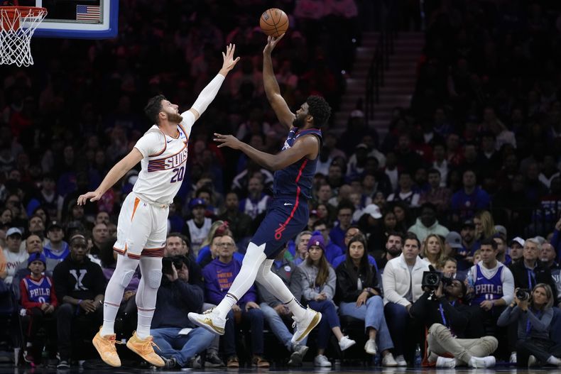 Joel Embiid de los 76ers de Filadelfia salta para lanzar el balón sobre Jusuf Nurkic de los Suns de Phoenix en el encuentro del sábado 4 de noviembre del 2023. (AP Foto/Matt Slocum)