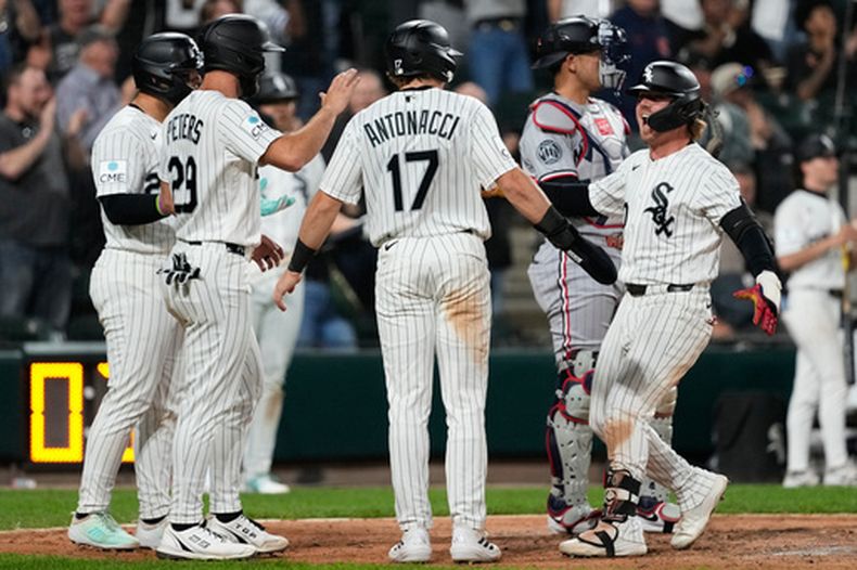 Chase Meidroth, derecha, de los Medias Blancas de Chicago, celebra con Edgar Quero, izquierda, Tristan Peters (29) y Sam Antonacci (17) después de batear un grand slam durante la séptima entrada del juego de béisbol de Grandes Ligas, el miércoles 27 de mayo de 2026, en Chicago. (AP Foto/Nam Y. Huh)