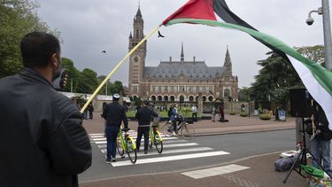 ARCHIVO - Un manifestante solitario ondea una bandera palestina fuera del Palacio de la Paz, sede de la Corte Internacional de Justicia, o Corte Mundial, en La Haya, Holanda, el 24 de mayo de 2024. (AP Foto/Peter Dejong, Archivo)