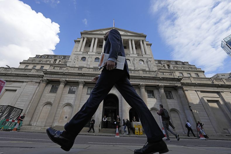 ARCHIVO - Un hombre camina frente al Banco de Inglaterra en el distrito financiero de Londres, el 11 de mayo de 2023. (AP Foto/Frank Augstein, Archivo)