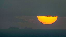 ARCHIVO - Barcos navegan por el golfo Pérsico hacia el estrecho de Ormuz mientras se pone el sol en Emiratos Árabes Unidos, el lunes 23 de marzo de 2026. (AP Foto, Archivo)
