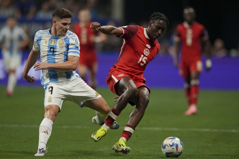 El atacante argentino Julián Álvarez (izquierda) y el zaguero canadiense Moise Bombito pugna por el balón en el partido por el Grupo A de la Copa América, el jueves 20 de junio de 2024. (AP Foto/Jason Allen)