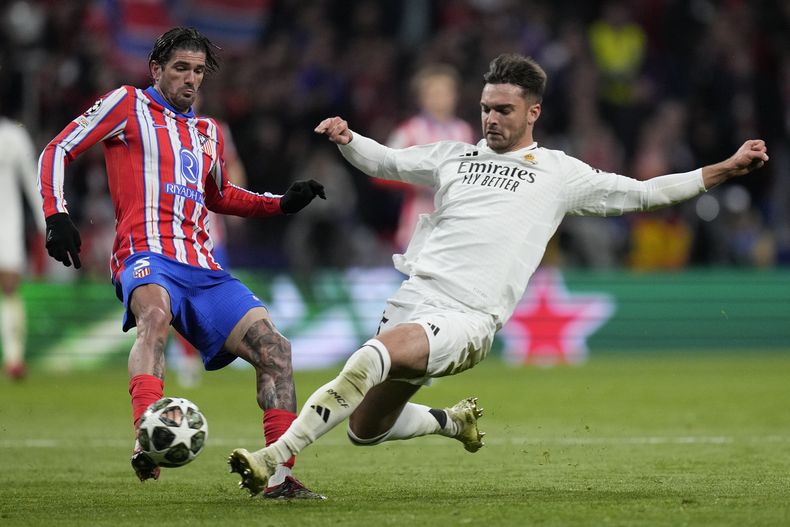 Rodrigo De Paul (izquierda) del Atlético de Madrid y Raúl Asencio pugnan por el balón en el partido por los octavos de final de la Liga de Campeones, el miércoles 12 de marzo de 2025. (AP Foto/Bernat Armangue)