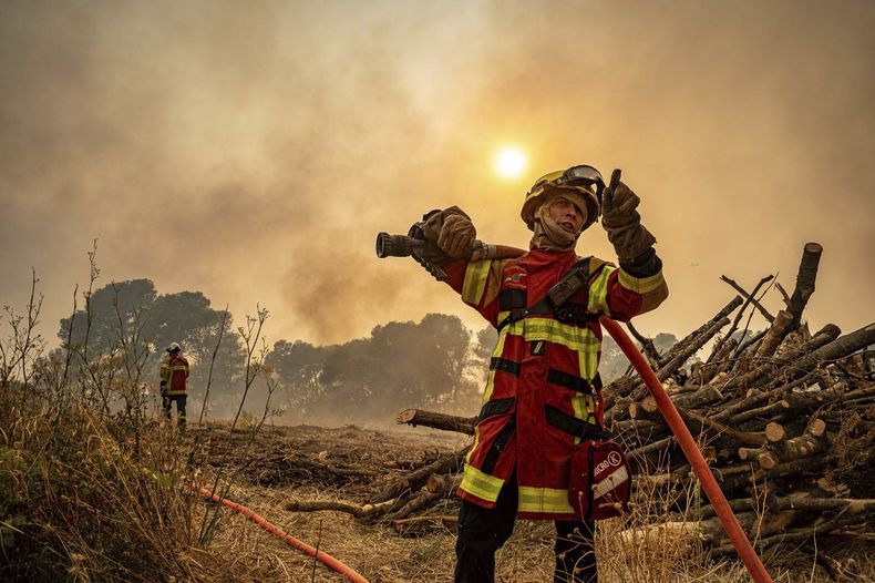 En la imagen, proporcionada por Securite Civile el jueves 7 de agosto de 2025, un bombero usa una manguera para combatir el incendio forestal cerca de Saint-Laurent-de-la-Cabrerisse, en el sur de Francia, el miércoles 6 de agosto de 2025. (Securite Civile vía AP)