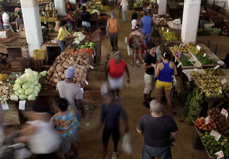 Archivo - Clientes de un mercado abierto en La Habana, Cuba, el 3 de diciembre de 2013. Las autoridades cubanas pusieron límites de precio en varios productos de primera necesidad el martes 9 de julio de 2024, en un intento de bajar la inflación. (AP Foto/Franklin Reyes, Archivo)