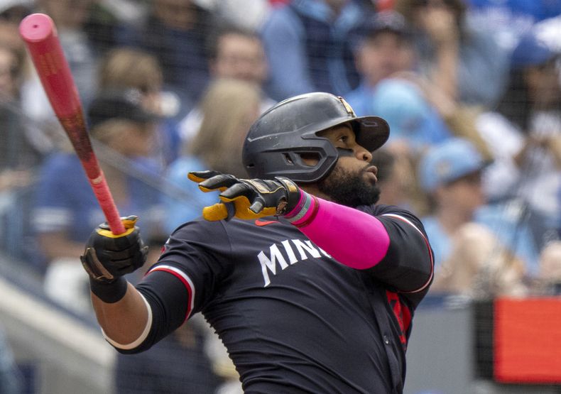 Carlos Santana de los Mellizos de Minnesota batea un jonrón ante los Azulejos de Toronto, el domingo 12 de mayo de 2024. (Frank Gunn/The Canadian Press vía AP)