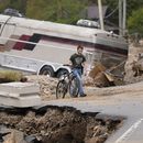 Dominick Gucciardo camina hacia su casa tras el paso del huracán Helene, el jueves 3 de octubre de 2024, en Pensacola, Carolina del Norte. (AP Foto/Mike Stewart)