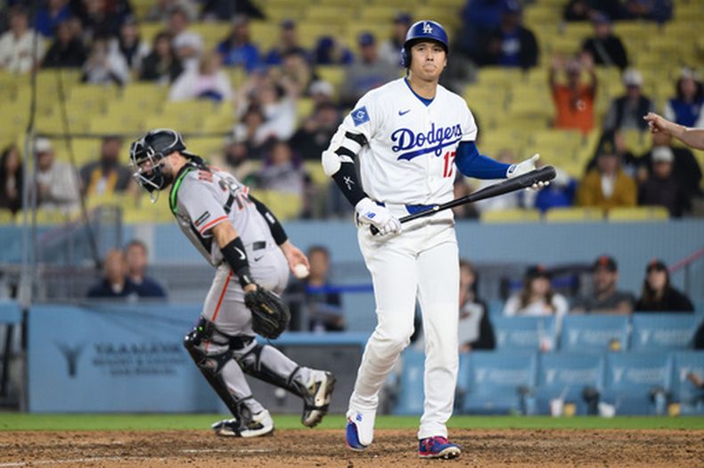 Shohei Ohtani, de los Dodgers de Los Ángeles, camina de regreso al dugout después de ser ponchado durante la novena entrada del juego de béisbol de Grandes Ligas contra los Gigantes de San Francisco, el lunes 11 de mayo de 2026, en Los Angeles. (AP Foto/Kyusung Gong)