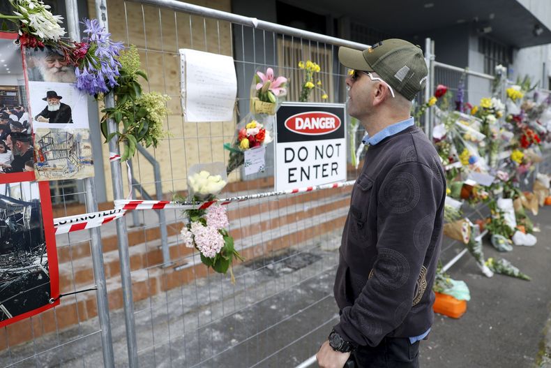 Un hombre lee los mensajes colocados en la cerca en el exterior de la sinagoga Adass Israel, dañada por un incendio, en Melbourne, el 9 de diciembre de 2024. (Con Chronis/AAP Image via AP)