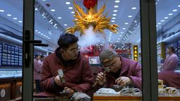 Trabajadores fabrican joyería de playa en una tienda en Beijing, el jueves 18 de diciembre de 2025. (AP Foto/Ng Han Guan)