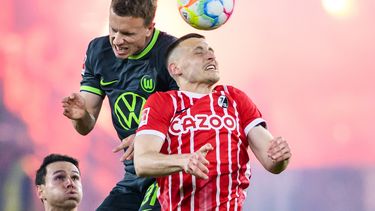 Yannick Gerhardt, del Wolfsburg, a la izquierda, y Roland Sallai, del Freiburg, disputan un balón durante el partido del viernes 19 de mayo de 2023, en Freiburgo, Alemania. (Tom Weller/dpa via AP)