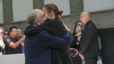 El director de cine italiano Giuseppe Tornatore, a la izquierda, recibe un abrazo cuando llega para presentar sus respetos al diseñador de moda Giorgio Armani, quien yace en el Armani/Teatro en Milán, en el norte de Italia, el sábado 6 de septiembre de 2025. (Foto AP/Antonio Calanni)