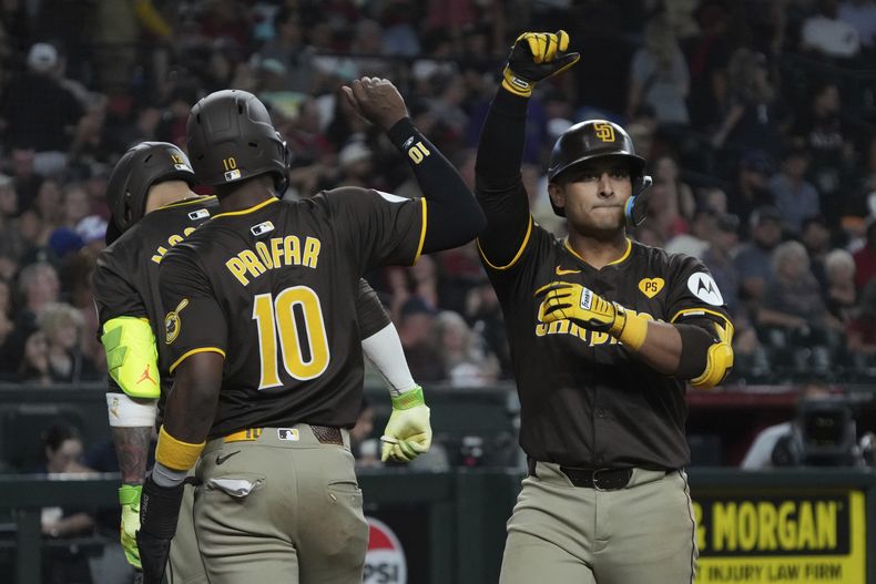 El colombiano Donovan Solano, de los Padres de San Diego, festeja con Jurickson Profar luego de conectar un jonrón de dos carreras ante los Diamondbacks de Arizona, el sábado 28 de septiembre de 2024 (AP Foto/Rick Scuteri)