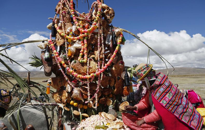 Una ind&iacute;genaa aymara deja una ofrenda de alimentos en la tumba de de un familiar en el D&iacute;a de Difuntos en Alaypata, Bolivia, 2 de noviembre de 2014. (AP Foto/Juan Karita)