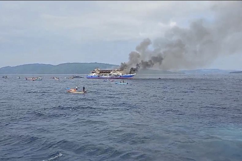 En esta imagen tomada de un video publicado por la Agencia Nacional Indonesia de Búsqueda y Rescate (BASARNAS), el humo se eleva sobre el barco de pasajeros KM Barcelona después de que se incendiara cerca de la isla de Talise en Sulawesi del Norte, Indonesia, el domingo 20 de julio de 2025. (BASARNAS via AP)