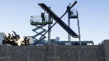 Operarios instalan un cartel con una X en lo alto de un edificio del centro de San Francisco que alberga la sede de la red social antes conocida como Twitter, renombrada ahora X por su propietario, Elon Musk, el 28 de julio de 2023. (AP Foto/Noah Berger)