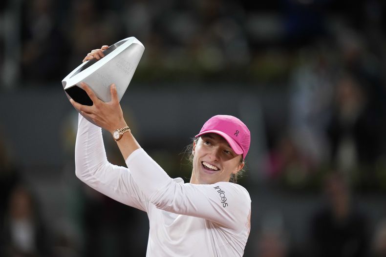La polaca Iga Swiatek alza el trofeo que la proclama campeona después de ganar la final del torneo de tenis Abierto de Madrid a Aryna Sabalenka, de Bielorrusia, en Madrid, España, el sábado 4 de mayo de 2024. (AP Foto/Bernat Armangue)